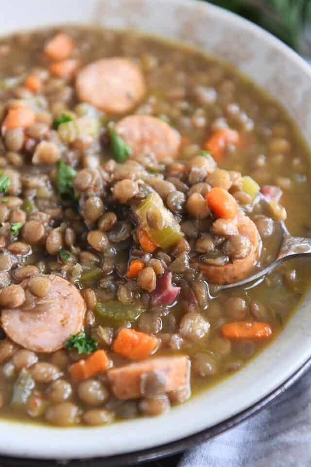 Stone bowl with ham bone lentil soup and veggies.