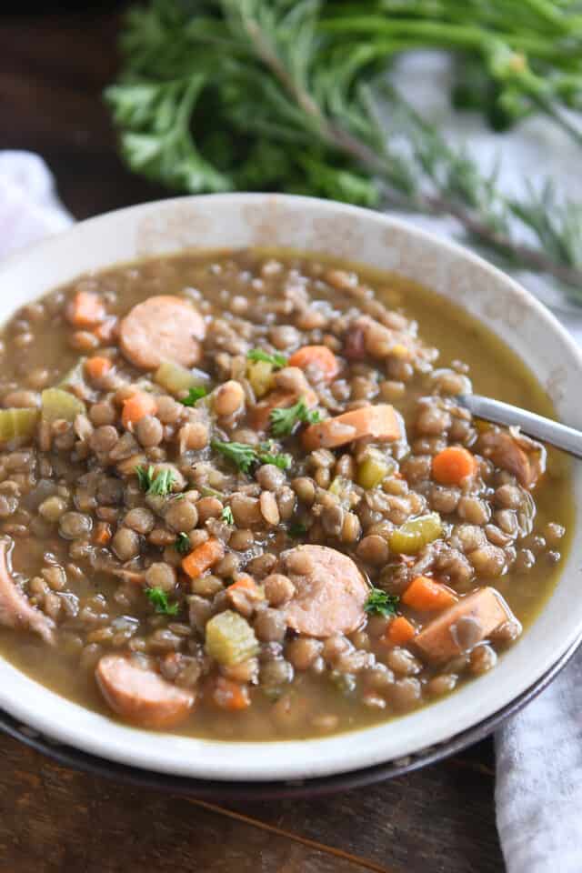 Stone bowl of leftover ham bone lentil soup with veggies.