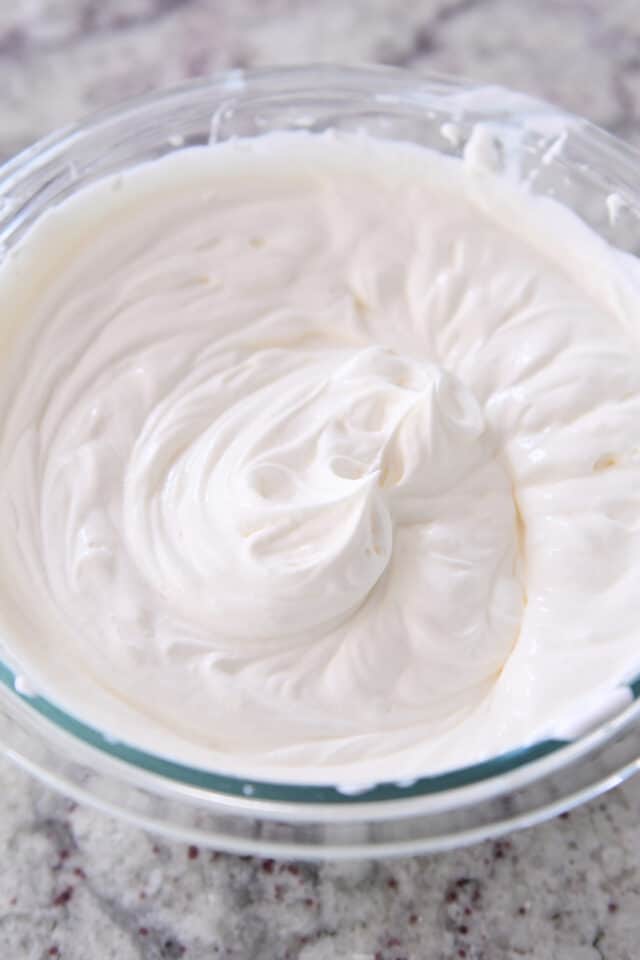 Glass bowl filled with marshmallow cream topping.