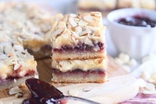 two raspberry white chocolate blondie bars on wood cutting board