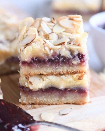 two raspberry white chocolate blondie bars on wood cutting board