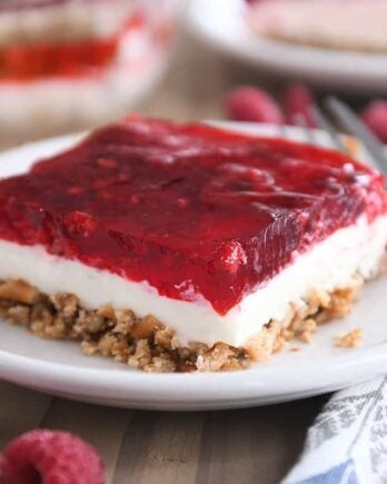 square of raspberry pretzel jello on white plate