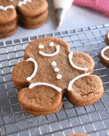 several decorated gingerbread people cookies on wire rack