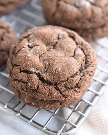 two chocolate ginger molasses cookies stacked on cooling rack