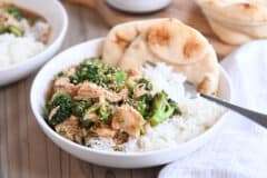 naan bread in white bowl with rice, chicken, broccoli and brown sauce