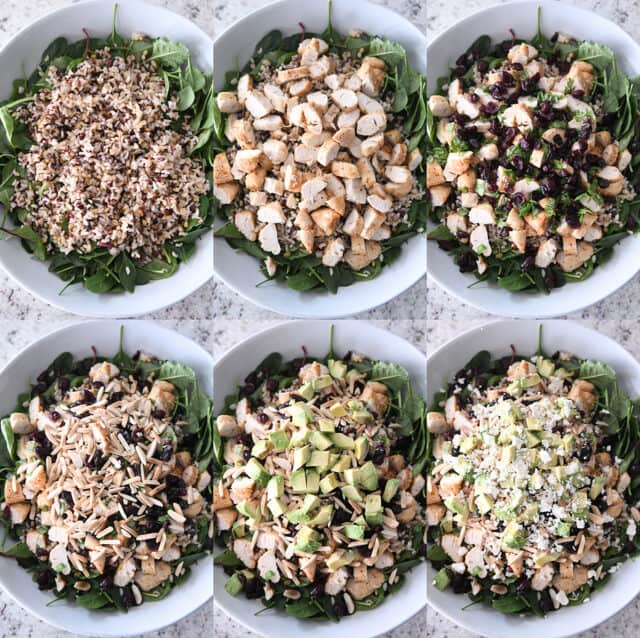 Assembling salad with greens, wild and brown rice, grilled chicken, craisins, almonds, avocados, feta cheese.