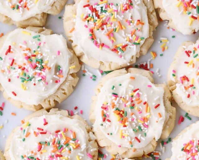 Top down view of frosted sugar cookies with colored sprinkles.