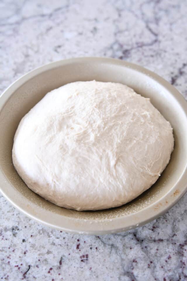 Sourdough peasant bread unbaked in metal pie tin.