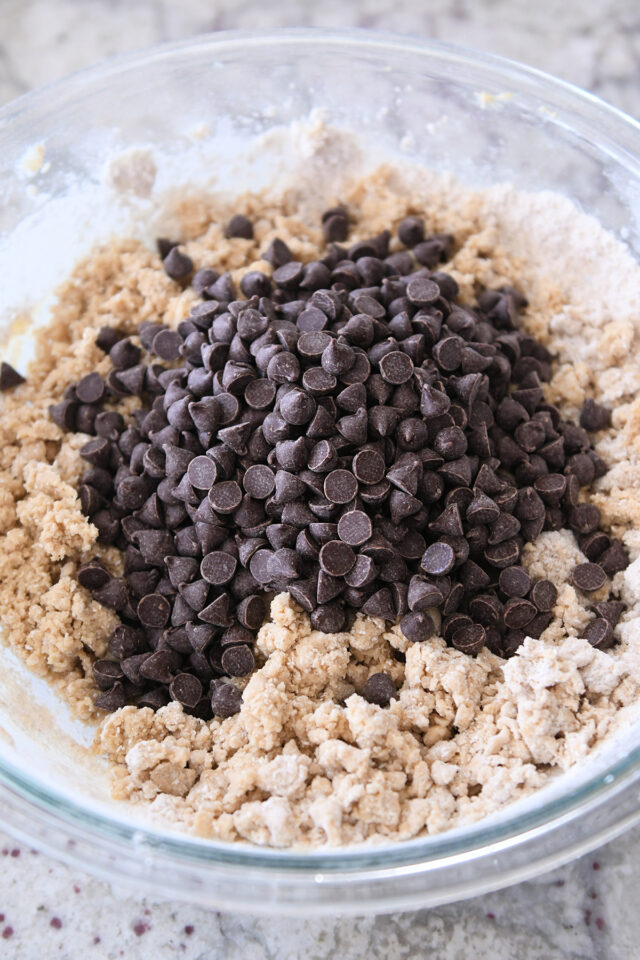 Glass bowl with cookie dough and chocolate chips.
