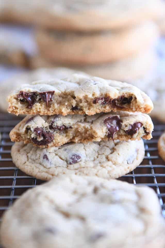 Two cookie halves stacked with melty chocolate chips.