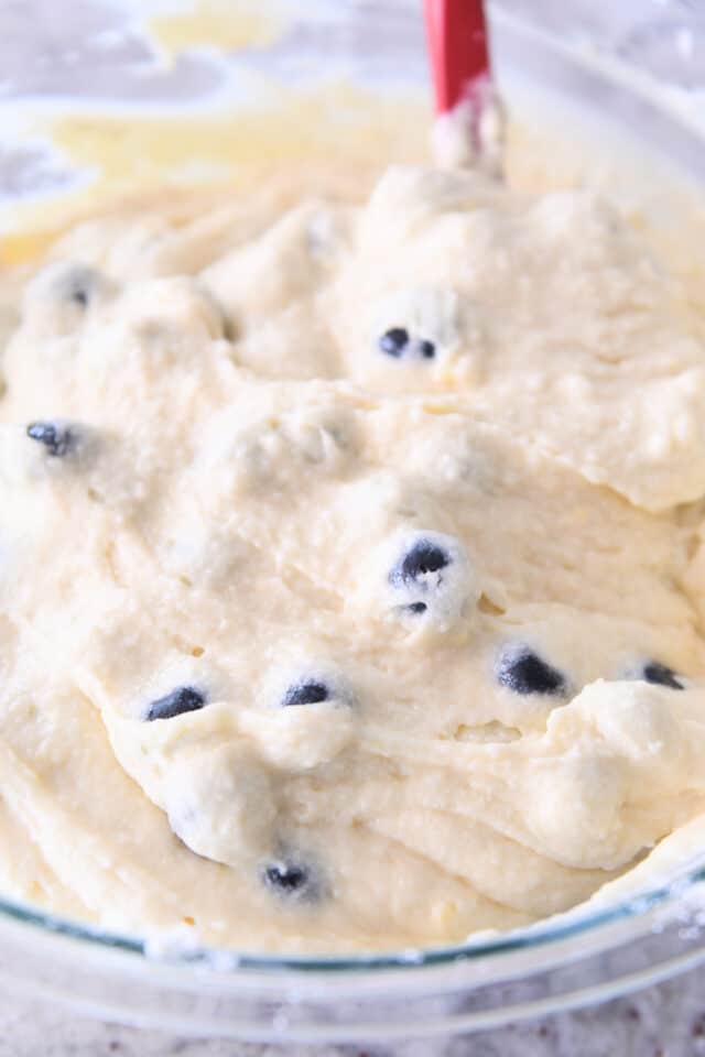 Lemon blueberry cake batter in glass bowl.