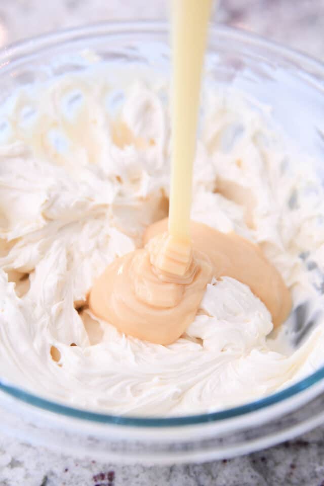 drizzling sweetened condensed milk in cheesecake batter