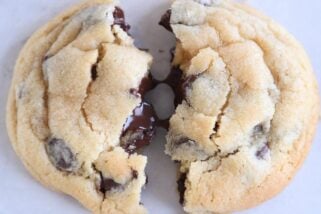 super soft chocolate chip cookie broken in half with melted chocolate chips