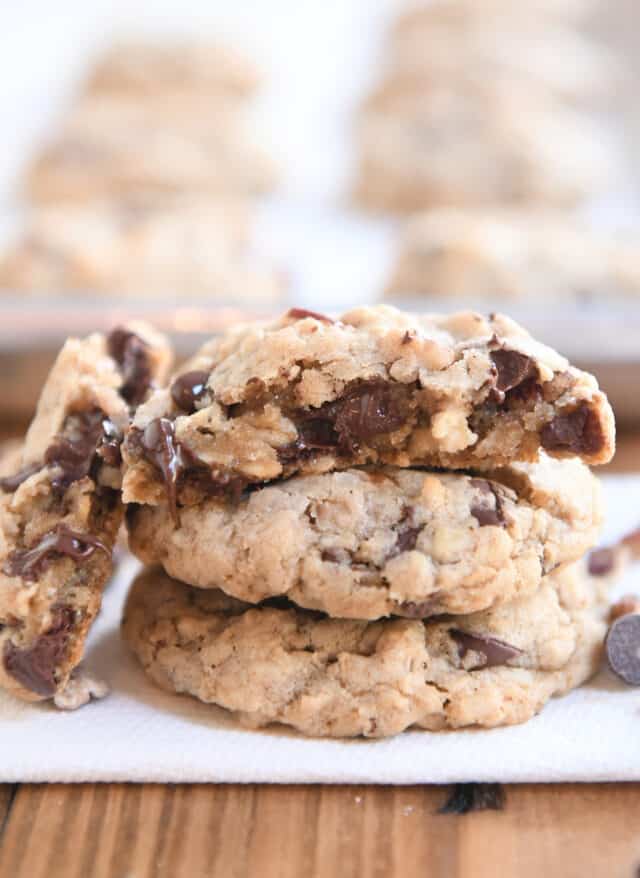 one half cowboy cookie on top of two stacked cookies.