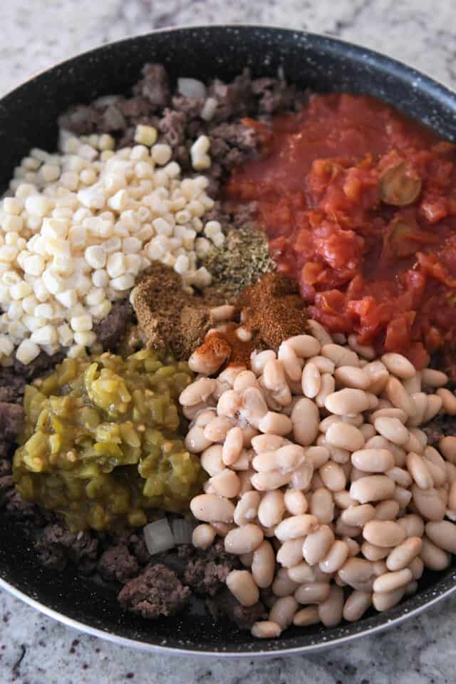 12-inch skillet with ground beef, canned tomatoes, beans, green chiles and corn.