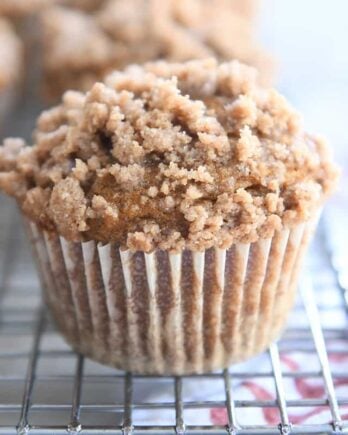 Pumpkin snickerdoodle muffin on cooling rack.