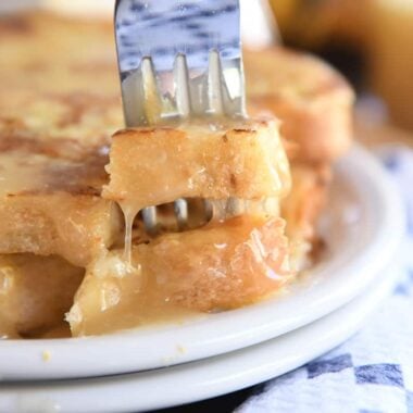 Fork piercing two bites of French toast.