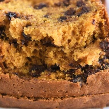 Two half slices of pumpkin chocolate chip bread.