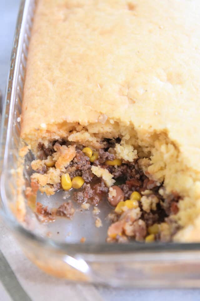 Glass 9X13-inch pan with beef, bean, corn, salsa and cornbread.