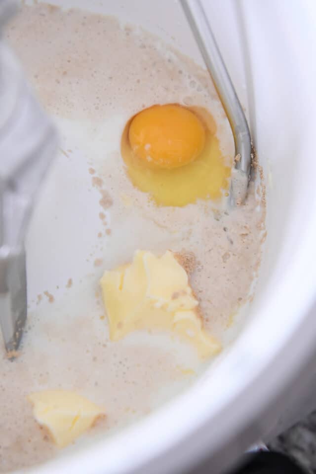 Eggs, yeast, milk and butter in mixing bowl with dough hook.
