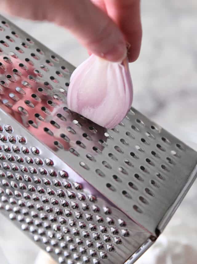 Grating onion on box grater.