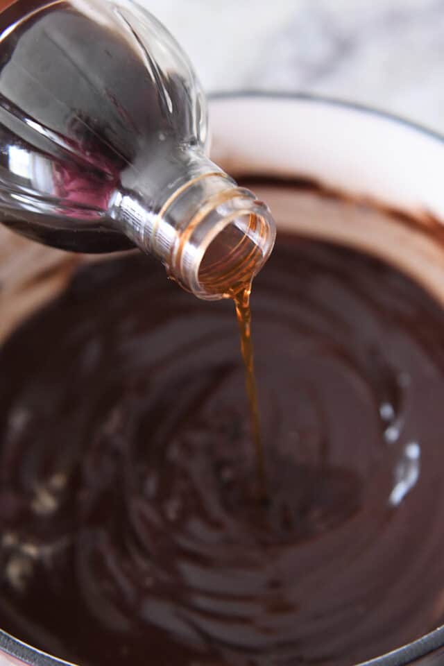 Pouring vanilla extract into chocolate fondue.
