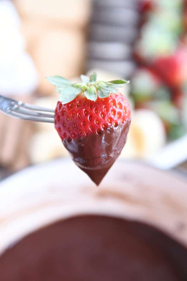 Chocolate dipped strawberry on fondue fork.