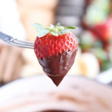 Chocolate dipped strawberry on fondue fork.