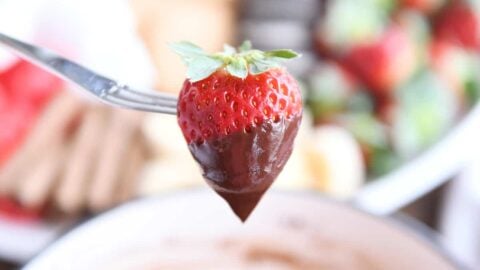 Chocolate dipped strawberry on fondue fork.