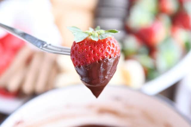 Chocolate dipped strawberry on fondue fork.
