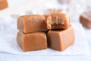 Four gingerbread caramels on white parchment paper.