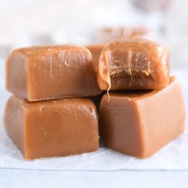 Four gingerbread caramels on white parchment paper.