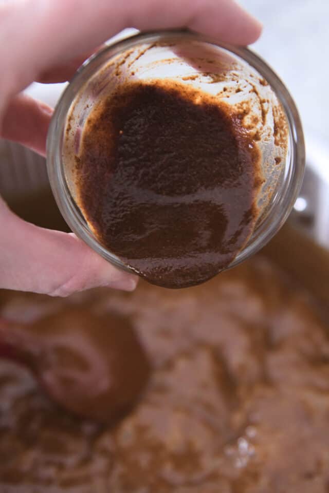 Pour vanilla and spices into hot caramel.