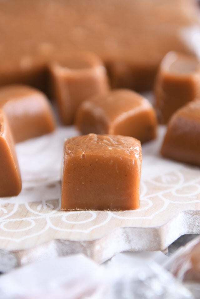 One gingerbread caramel square on decorated wood board.