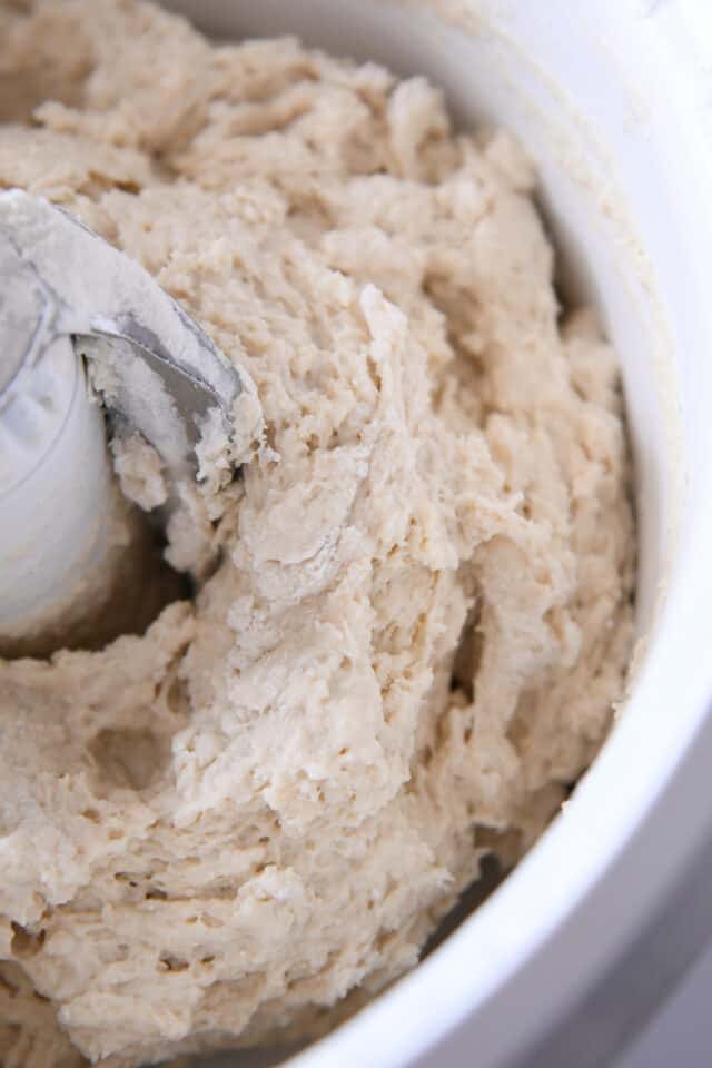 Shaggy bread dough mixing in Bosch mixer.