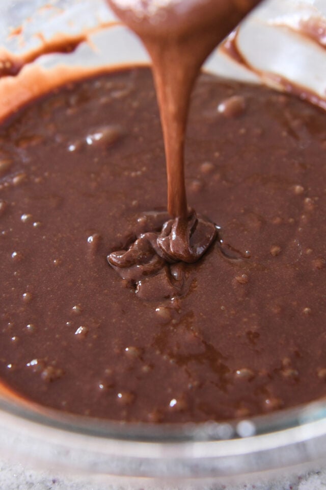 Chocolate cake batter in glass bowl.