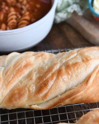 Loaf of twisted croissant French bread on cooling rack.