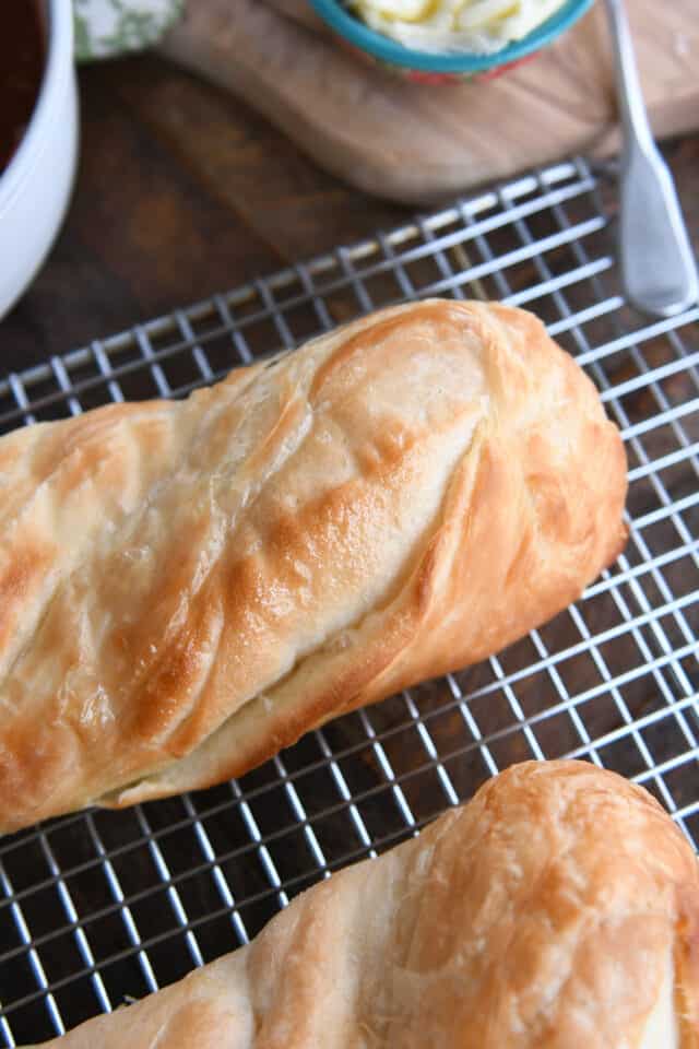 Buttery croissant French bread on cooling rack.