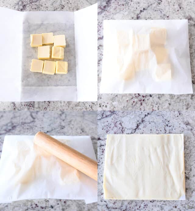 Butter cubes in parchment, parchment folded, using rolling pin to flatten butter into thin sheet.
