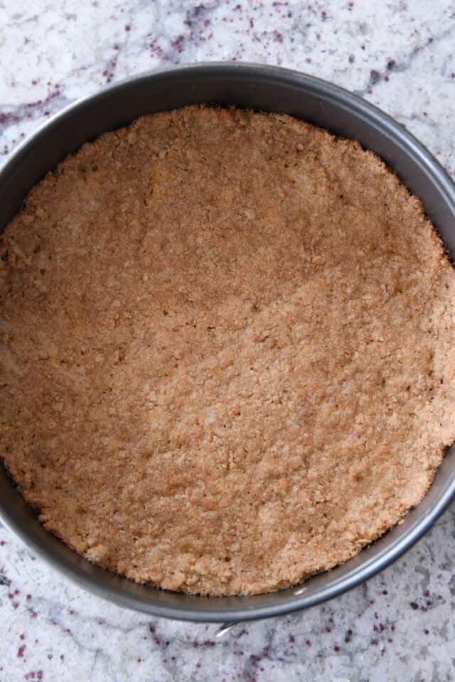 Baked graham cracker crust in springform pan.