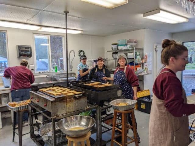 Making French toast in camp kitchen.