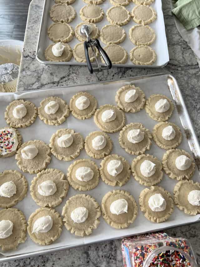 Frosted swig sugar cookies on sheet pan.