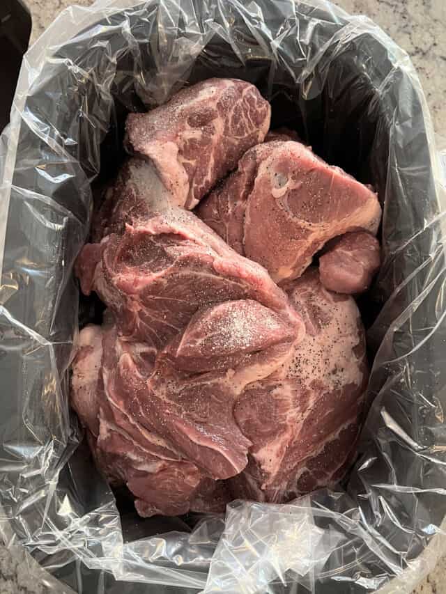 Pork shoulder in lined roasting pan.