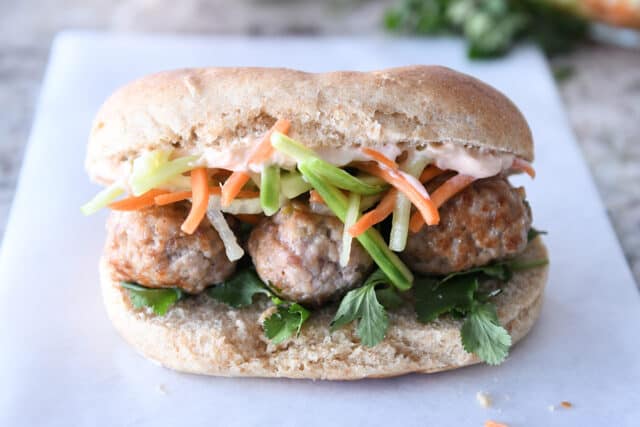Banh mi meatball sub on parchment paper.