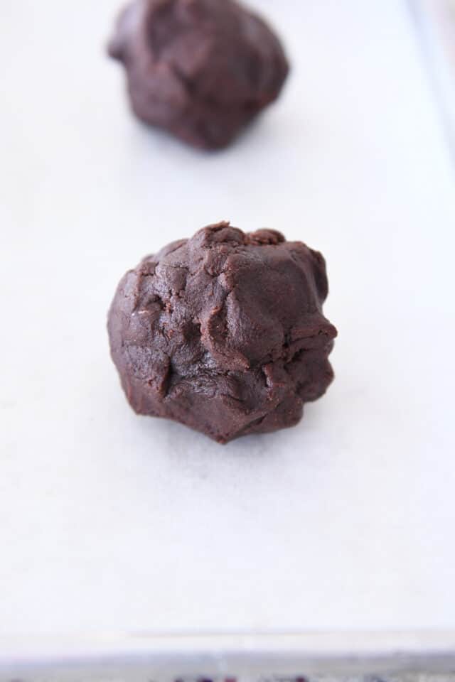 Double chocolate cookie dough ball on parchment paper.