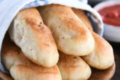 Five breadsticks in white and blue towel.