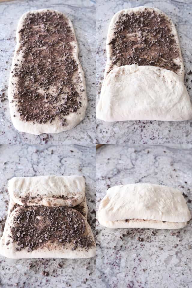 Folding up French bread dough over chopped chocolate.
