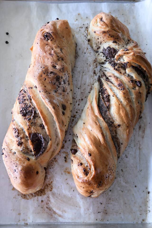 Two baked loaves of chocolate croissant French bread.