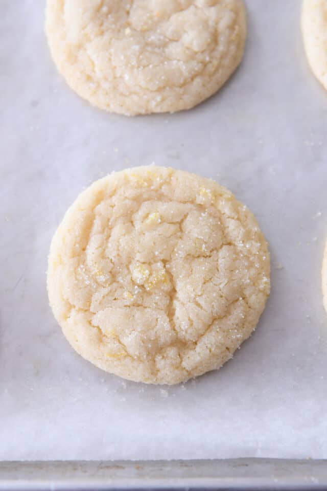 Baked lemon sugar cookie on sheet pan with parchment paper.