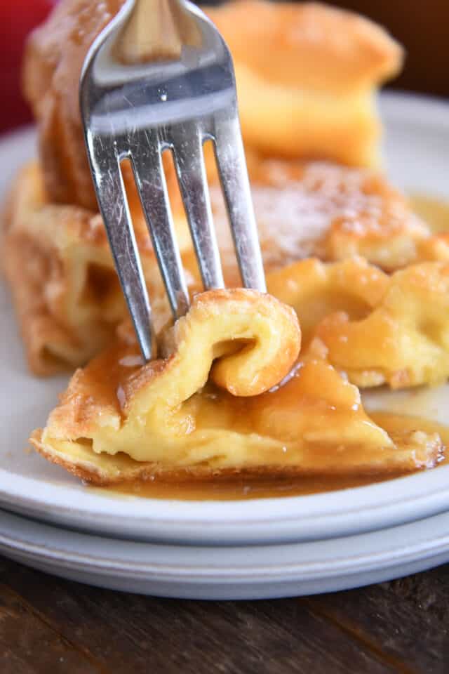 Fork spearing curly bite of German pancake.